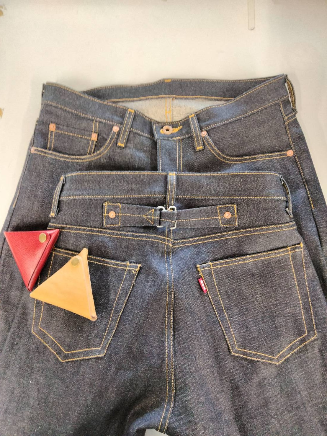 OEM jeans production example with custom pockets, rivets and cinch-back details