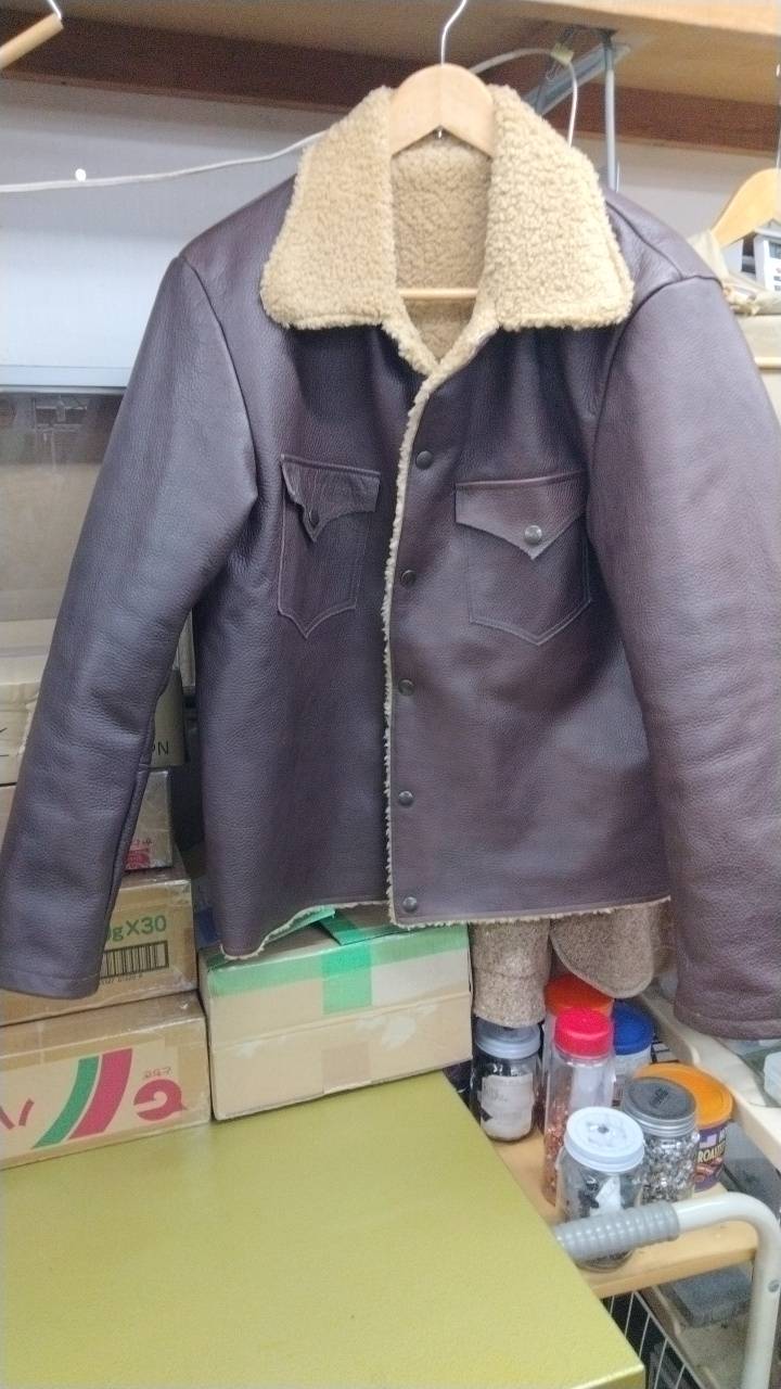 OEM jacket production example with dark outer fabric and boa-style lining